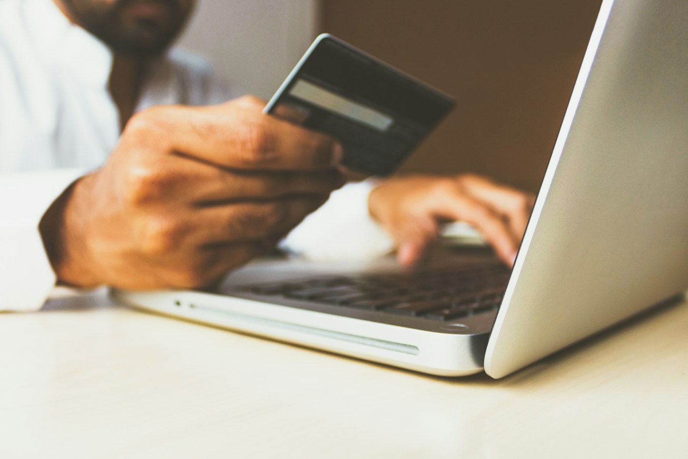 A payment card and laptop used for online purchases